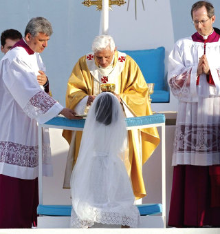 Benoît XVI donne la première communion